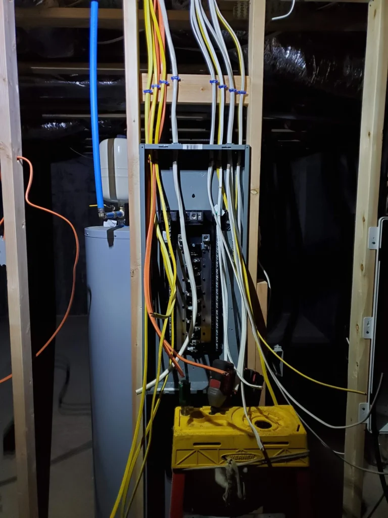 Residential electrical panel wiring upgrade in progress with organized circuit installation