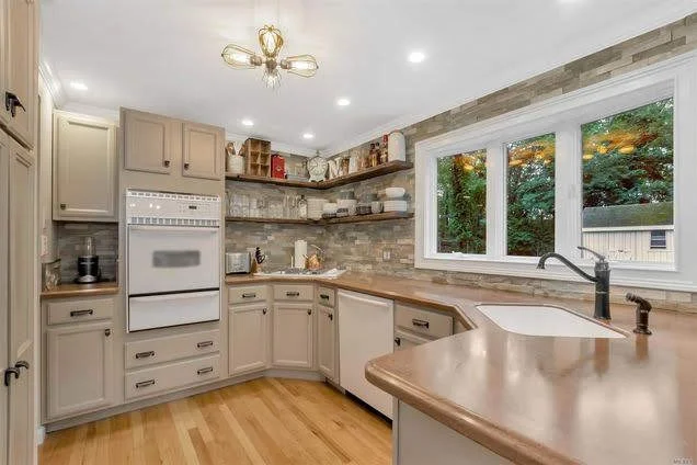 Bright modern kitchen featuring recessed LED lights and upgraded electrical lighting design