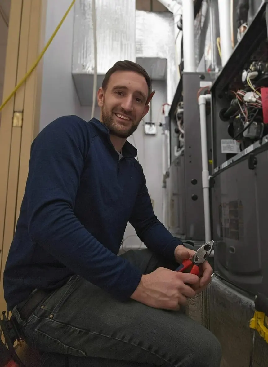 Upgrade or repair: Electrician working on HVAC electrical components with tools