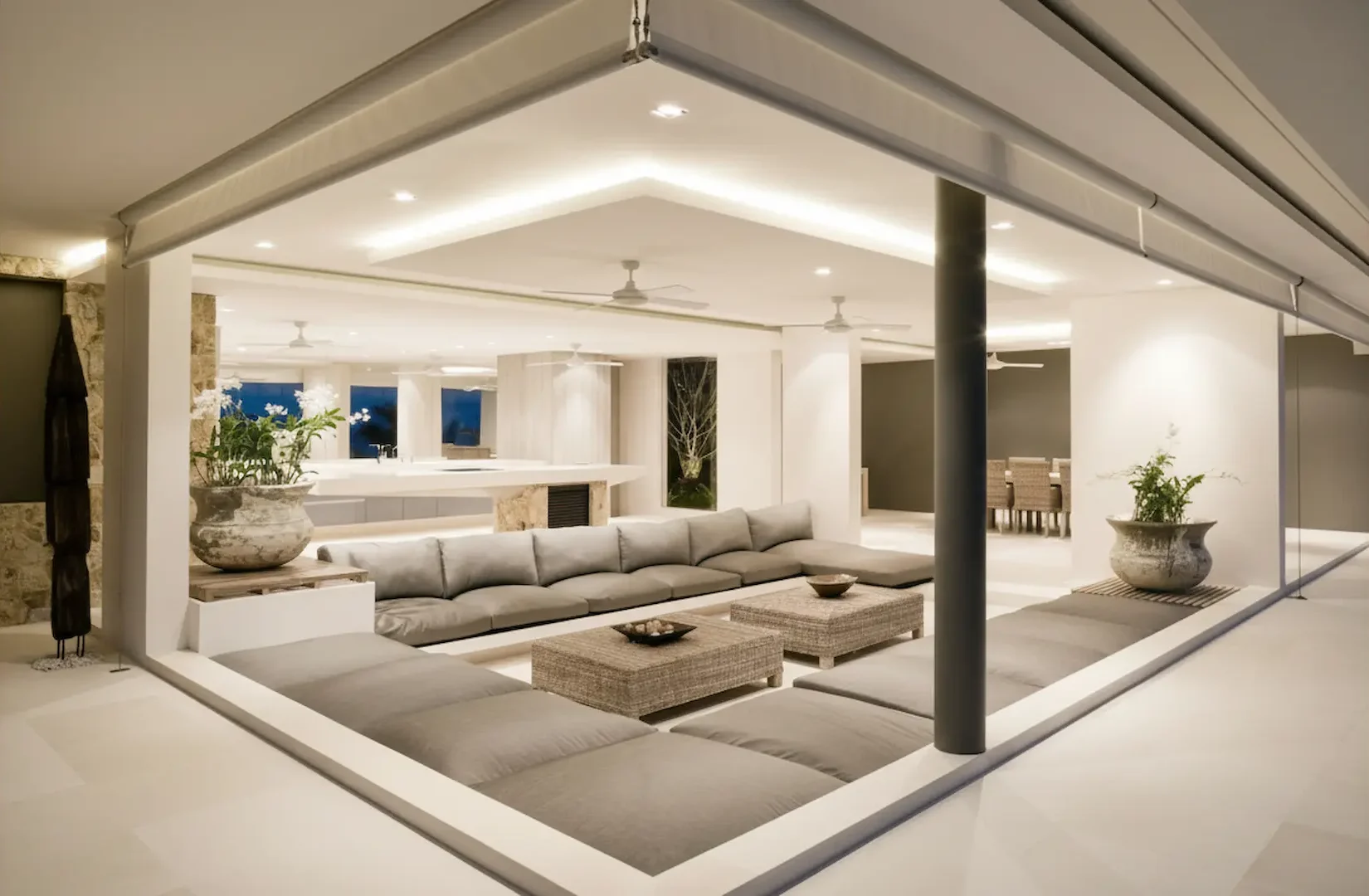 A modern luxury living room featuring large gold halo pendant lights and recessed ceiling spots that may require professional lighting repair service to maintain optimal brightness.