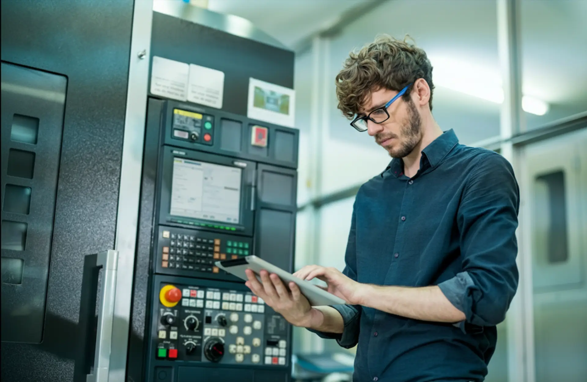 Upgrade Your Electrical Panel: A professional technician performing a high-tech electrical panel upgrade and system configuration using a digital tablet in a modern facility.